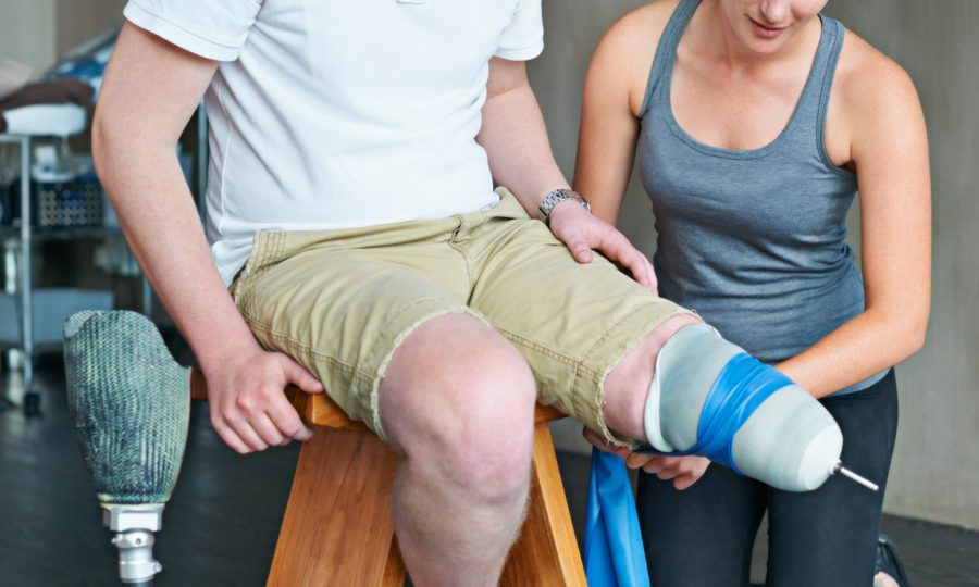 Shot of a female physiotherapist having a session with a young male amputee